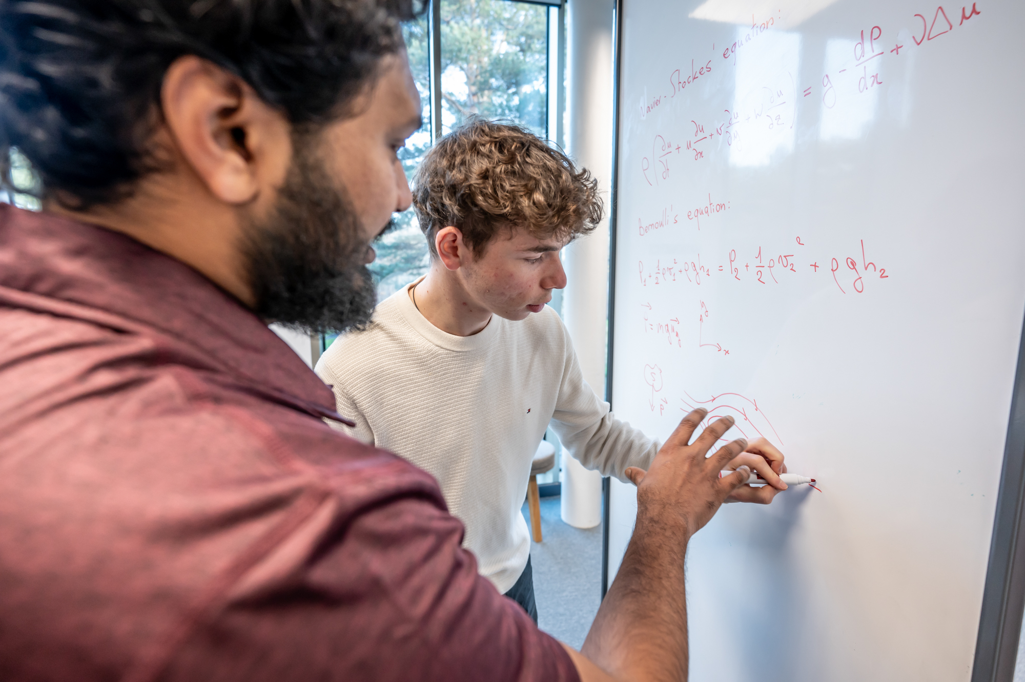 Students working on an equation on a whiteboard