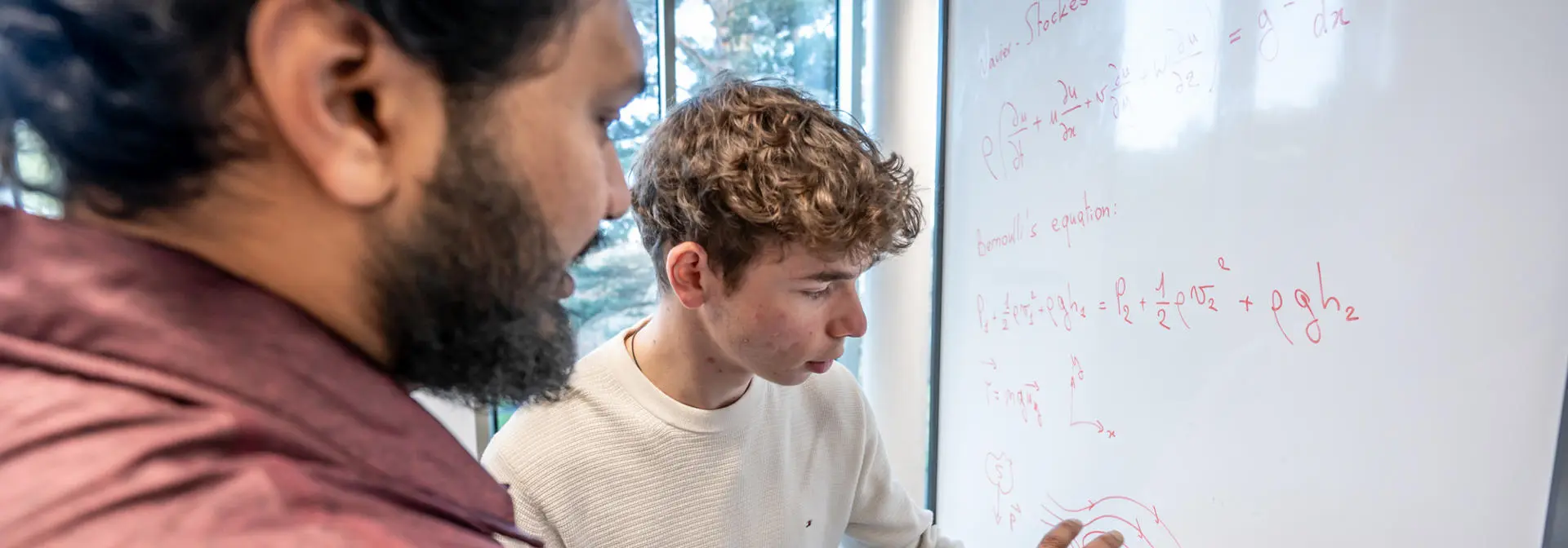 Students working on an equation on a whiteboard