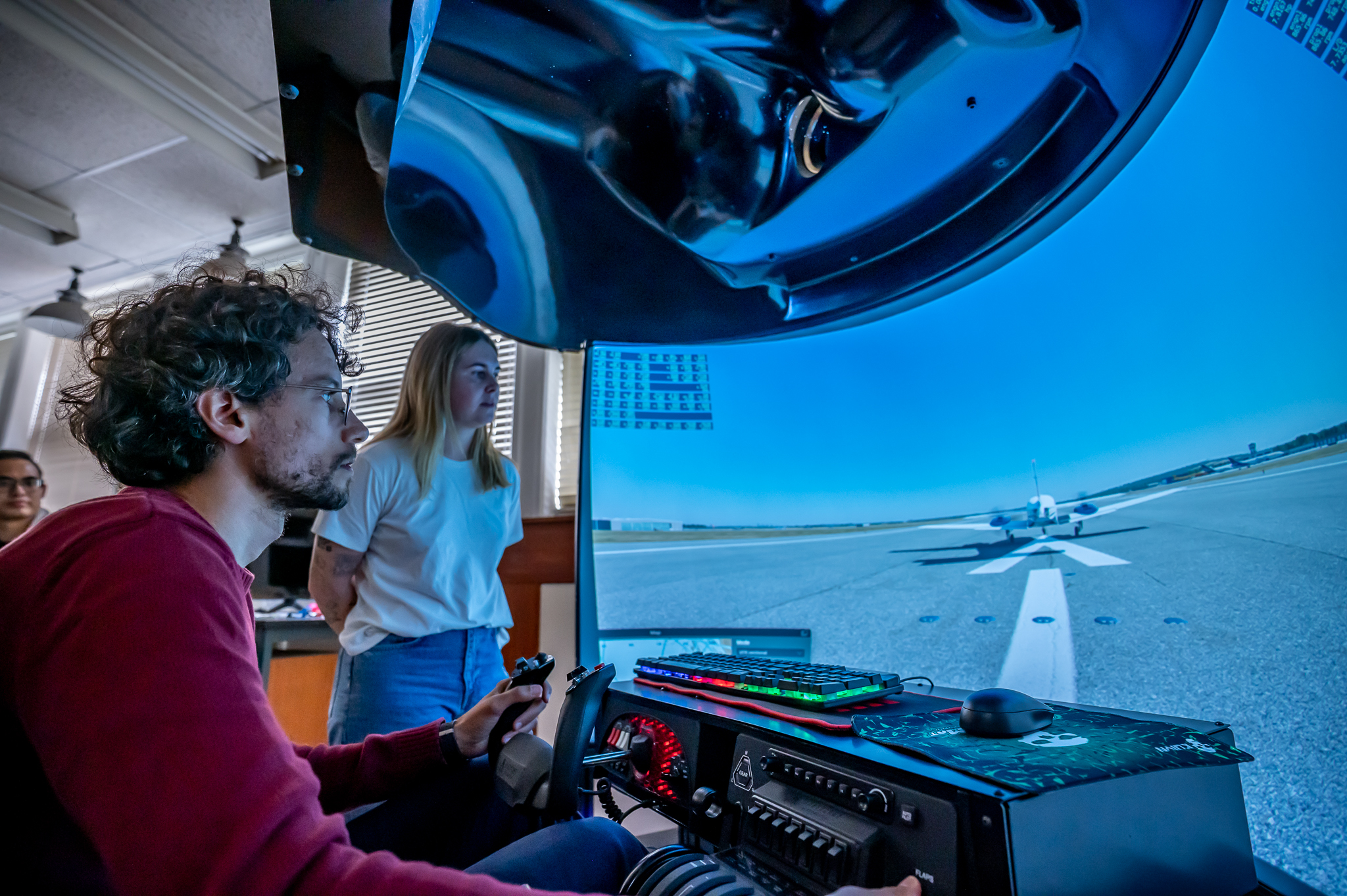 Student operating a flight simulator