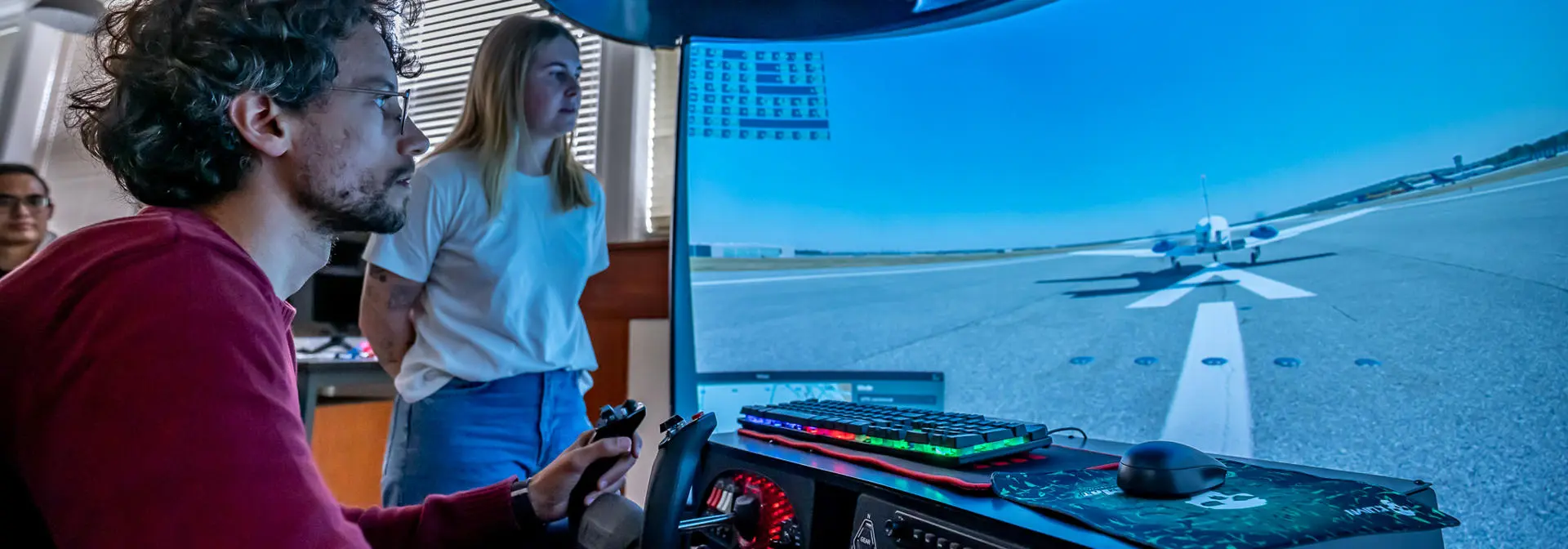 Student operating a flight simulator