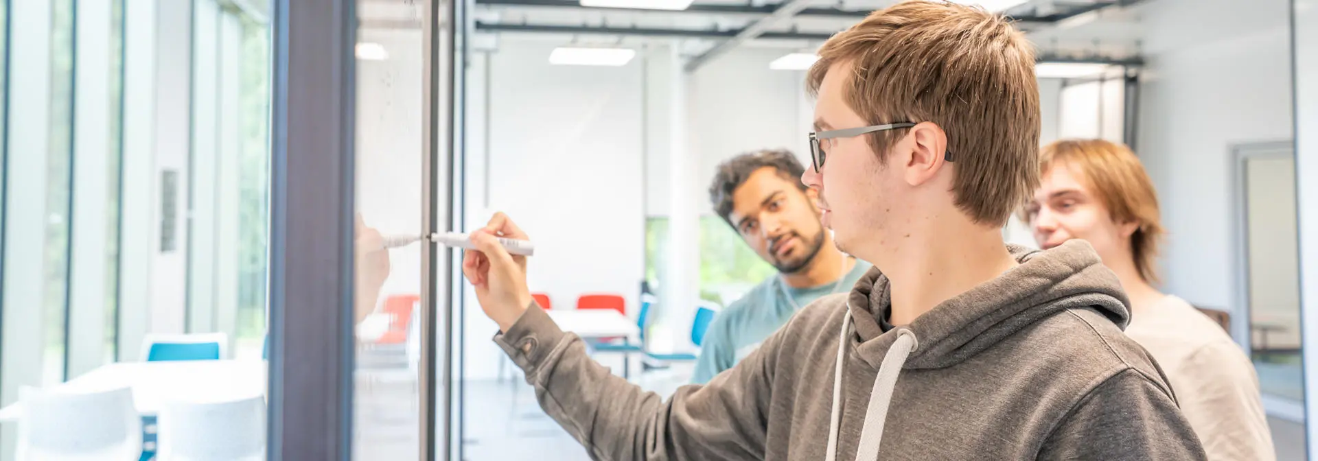 Students working on a question and writing on a whiteboard