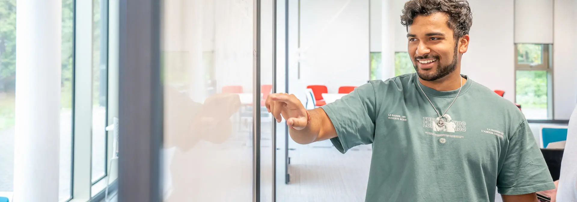 Student pointing at a whiteboard