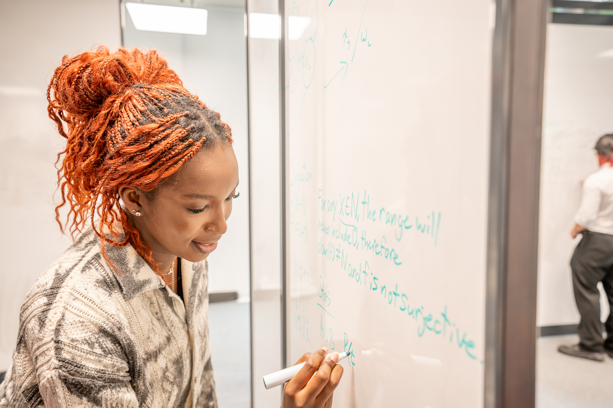 Student writing on a whiteboard