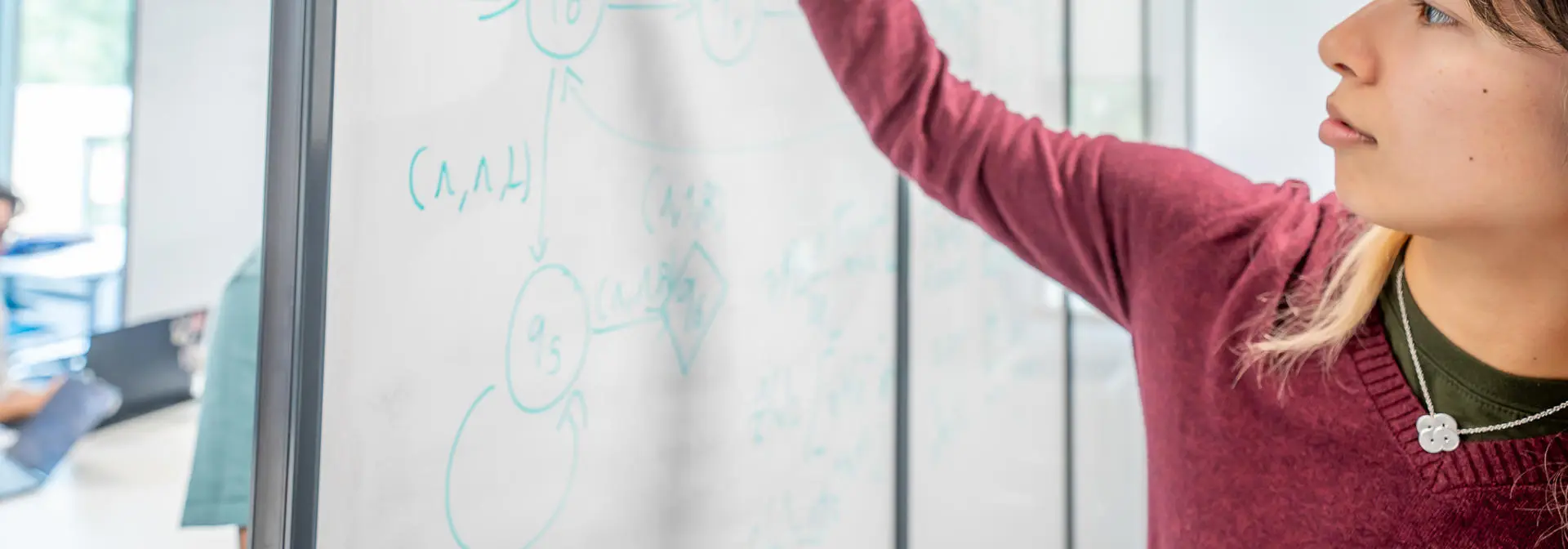 Student working on a whiteboard