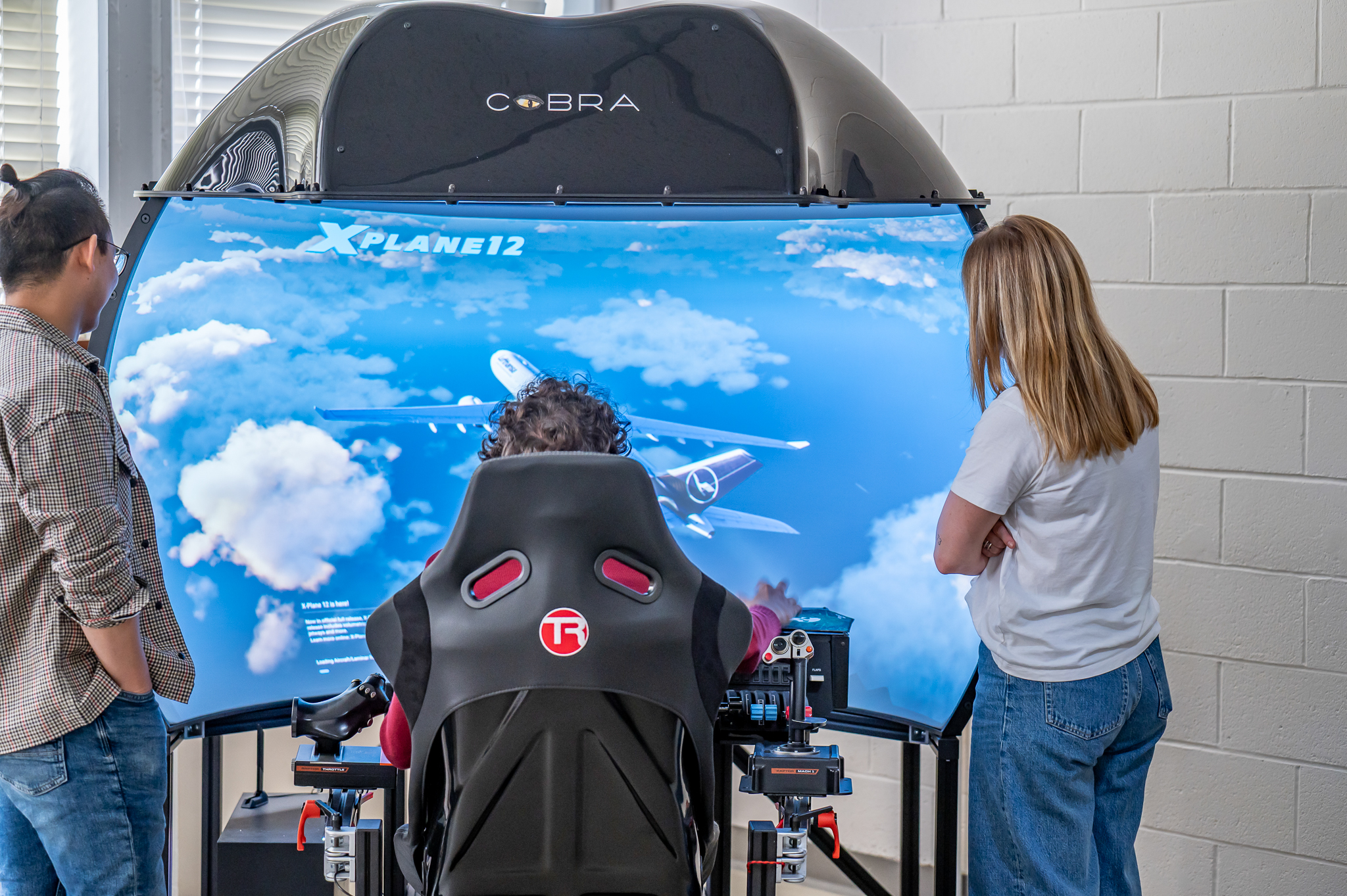 Aerospace Engineering students observe a flight simulator demonstration