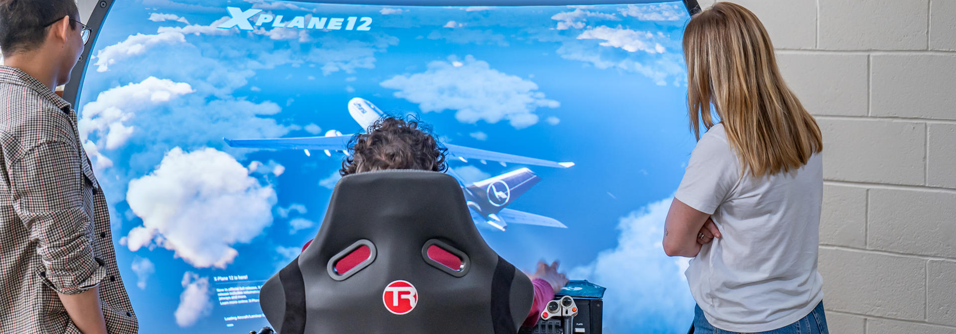 Aerospace Engineering students observe a flight simulator demonstration