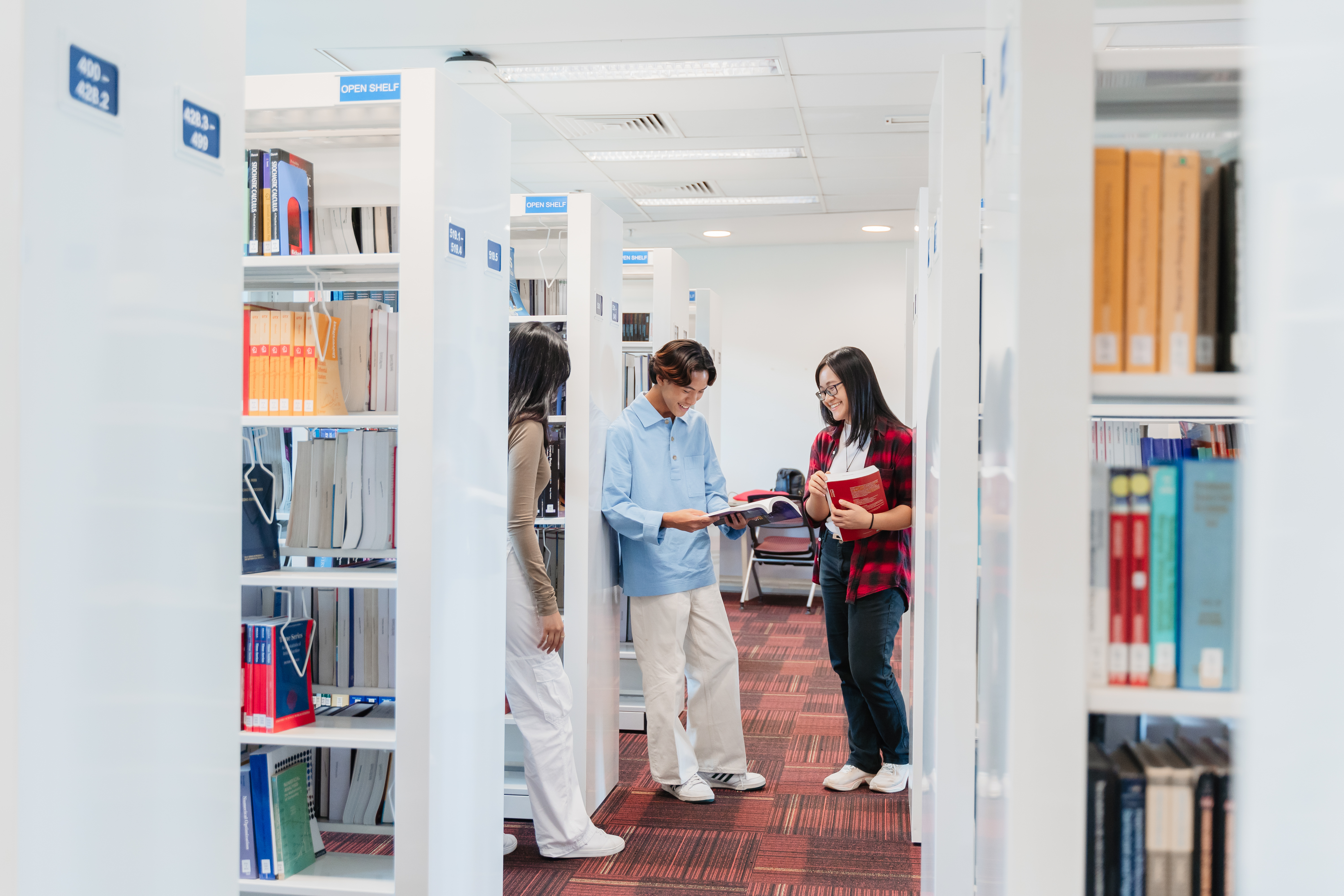 Students reading books in library