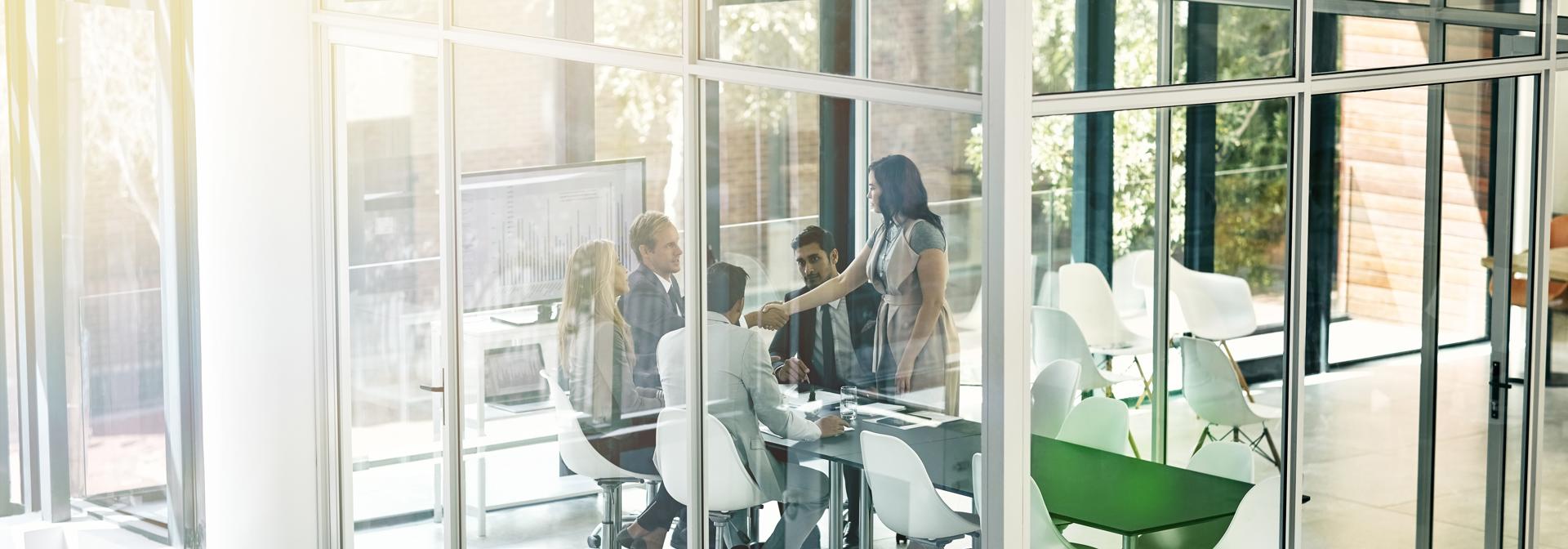Business meeting in a modern glass meeting room
