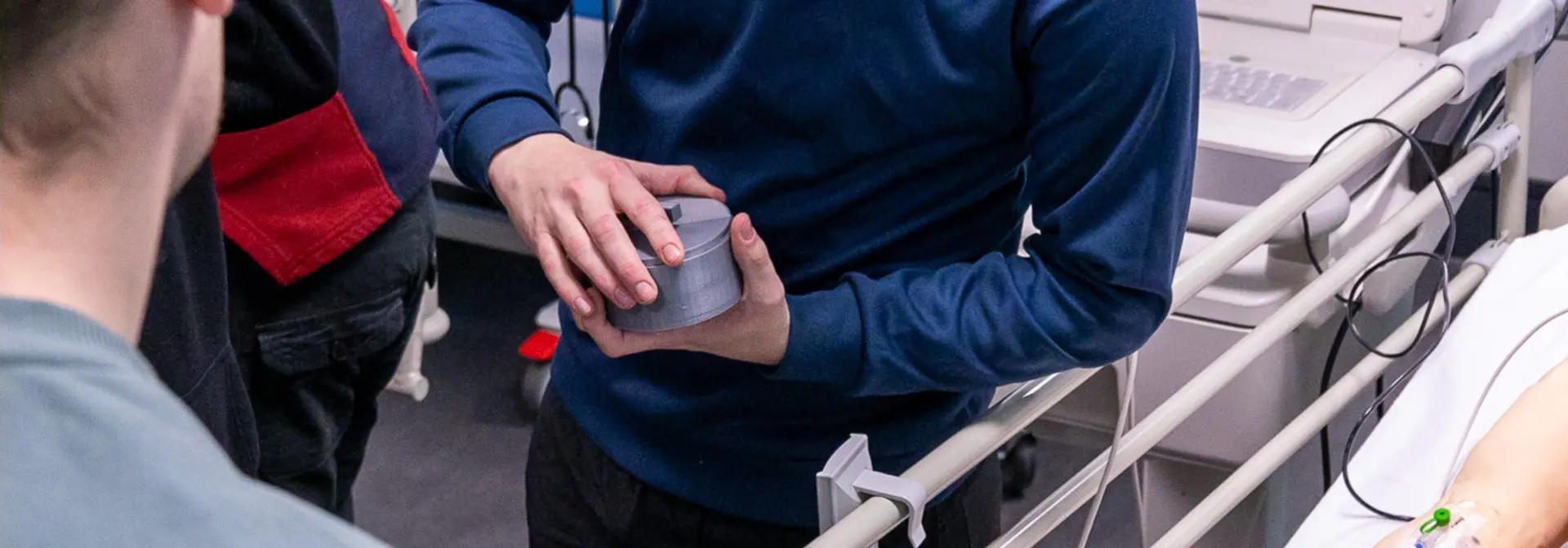 Student working in a simulation medical situation in our immersive suite, testing their engineered product.