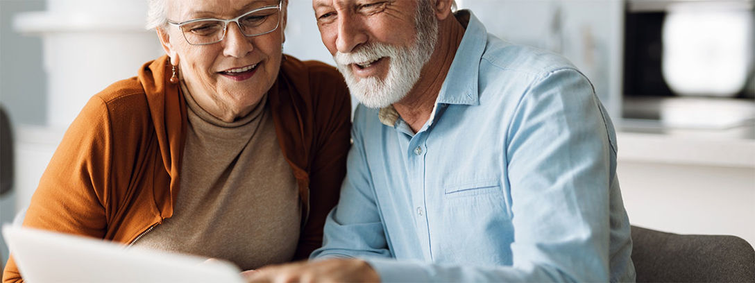 Ageing brings additional challenges for many people. Two people looking at laptop