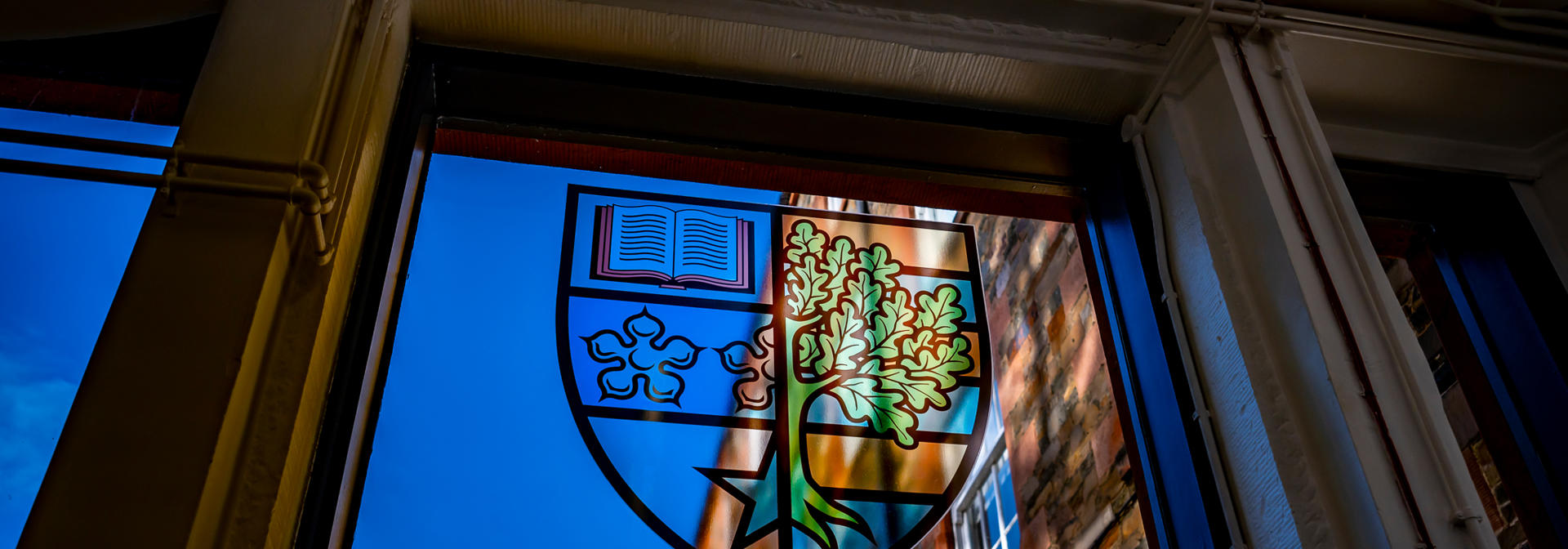 The Heriot-Watt University badge in a stained glass window.