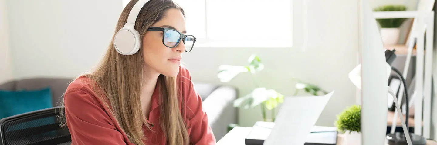 An individual working from home works on interpretation with headphones