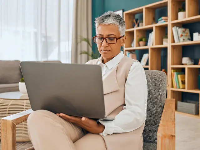 An individual working on a laptop in a psychologist office
