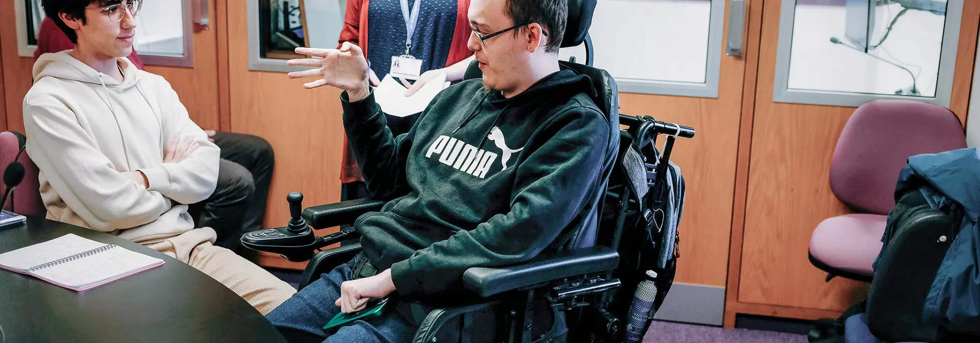 Three individuals in the interpreting and translation centre.