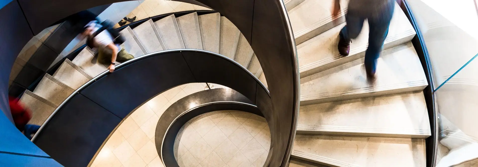 pople walking down a spiral staircase