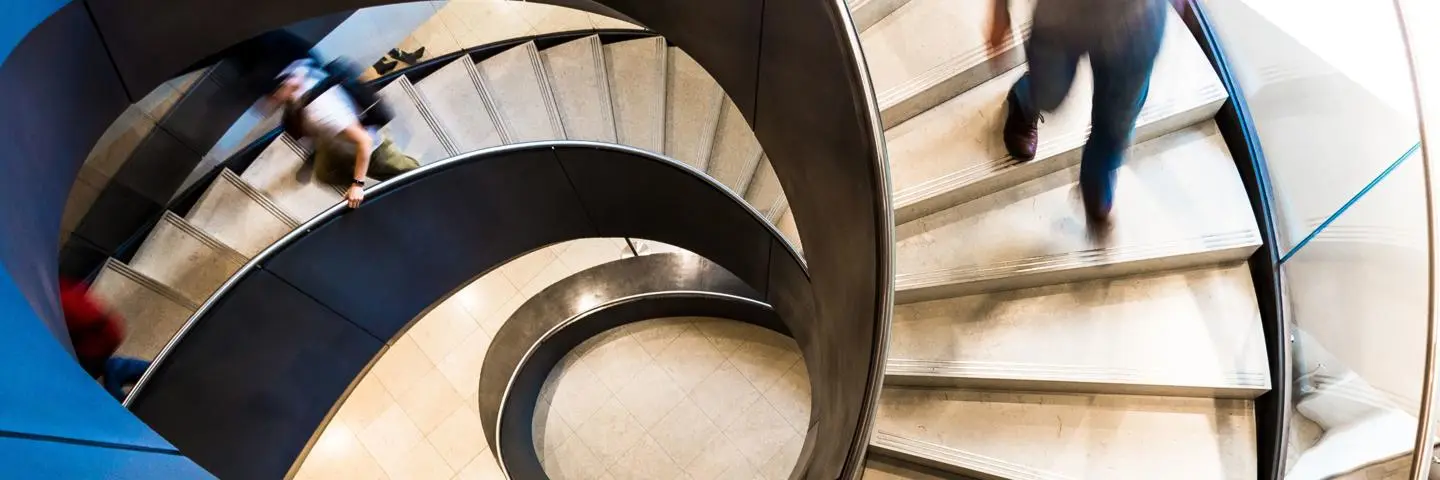 pople walking down a spiral staircase