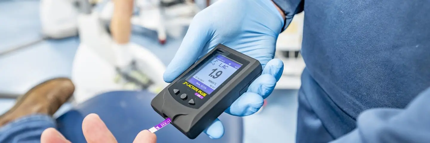 Close-up view of a monitoring device held by a student