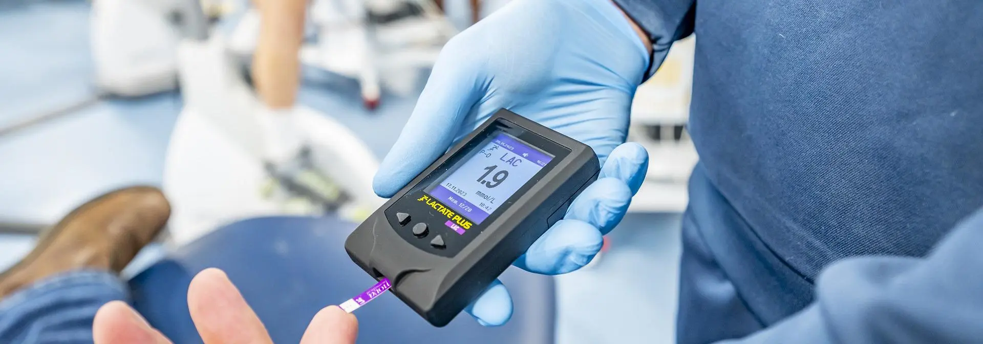 Close-up view of a monitoring device held by a student