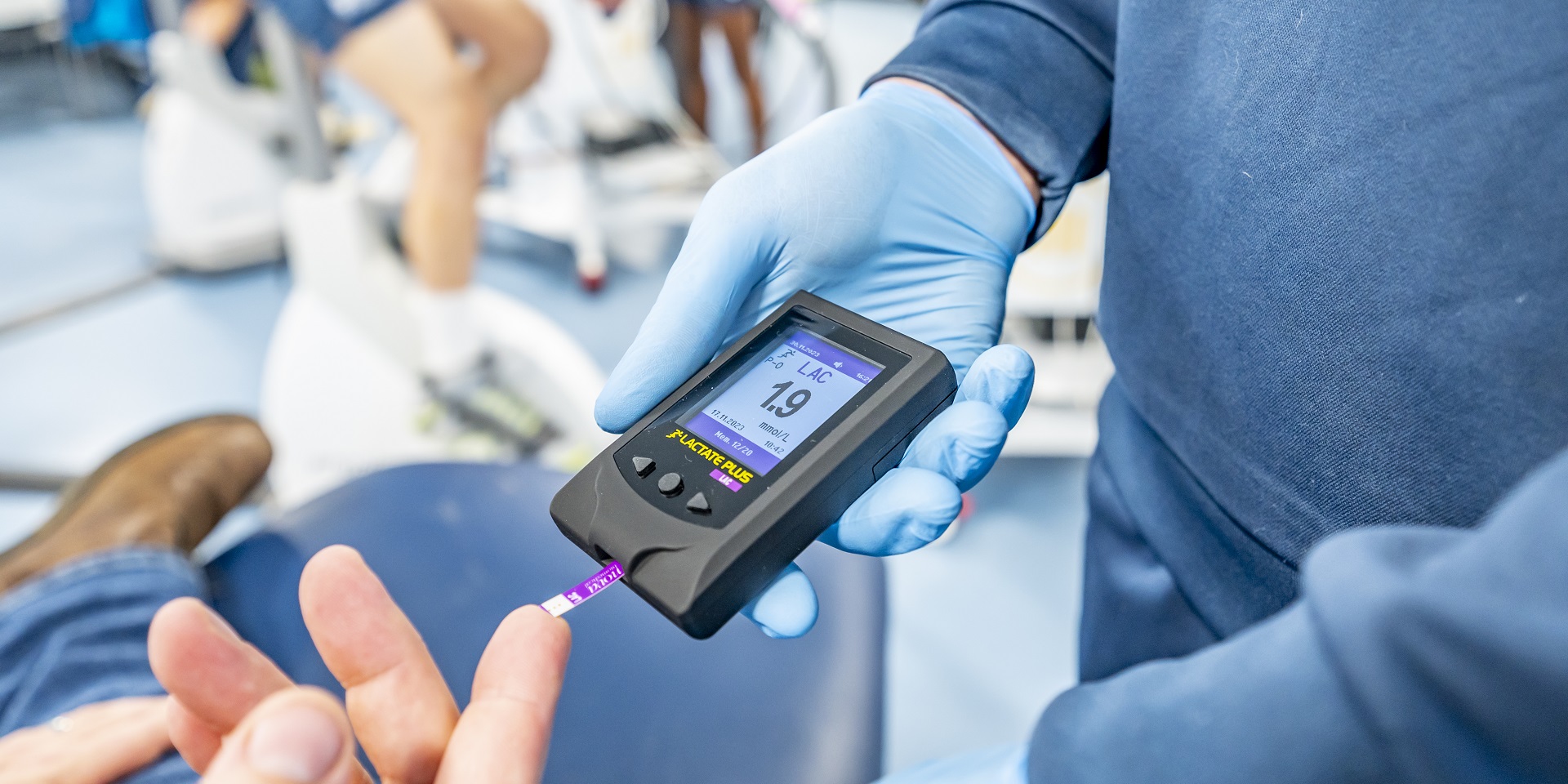 Close-up view of a monitoring device held by a student