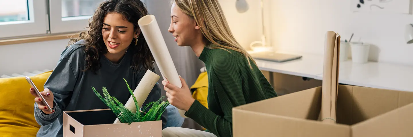 Two individuals unpacking boxes