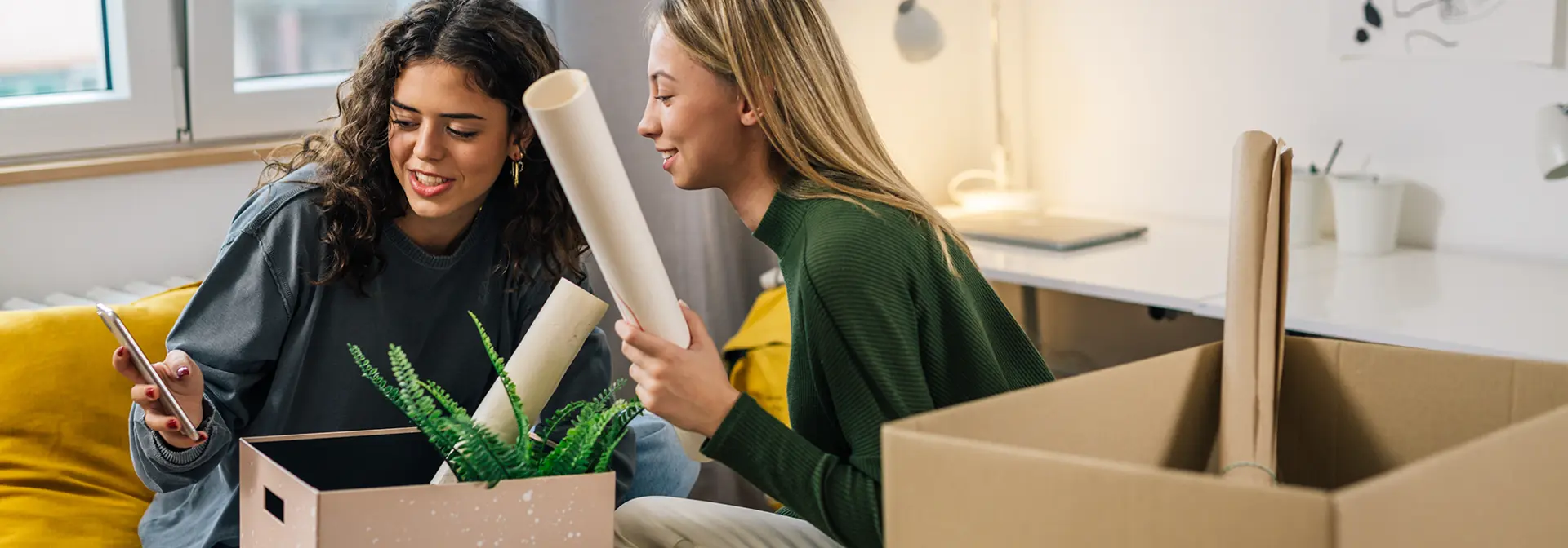 Two individuals unpacking boxes