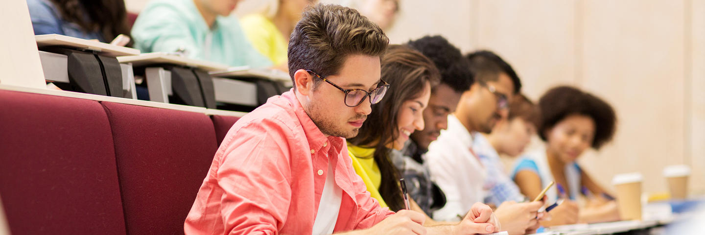 Students in a lecture taking notes