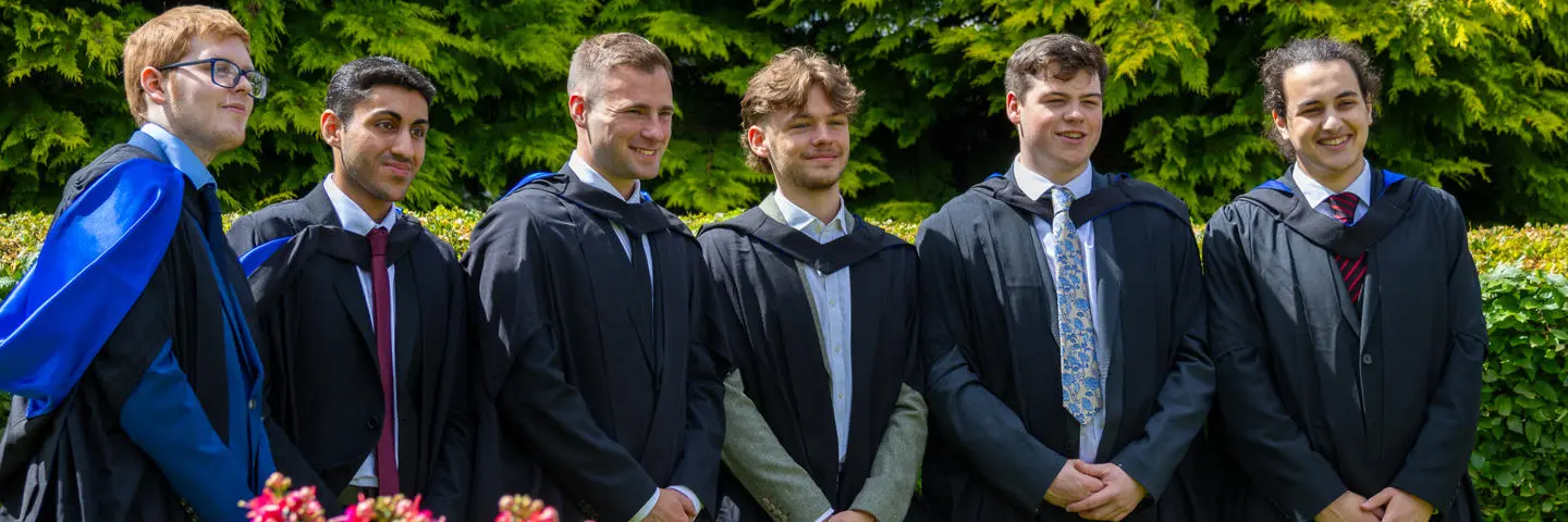 Six undergraduate graduates posing for photographs on Edinburgh campus.