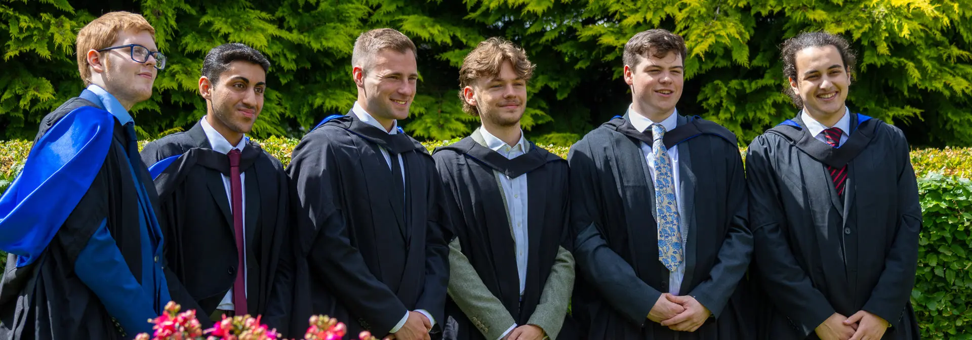 Six undergraduate graduates posing for photographs on Edinburgh campus.