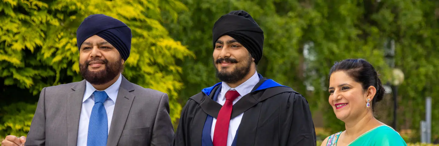An undergraduate posing for photographs at graduation in Edinburgh.