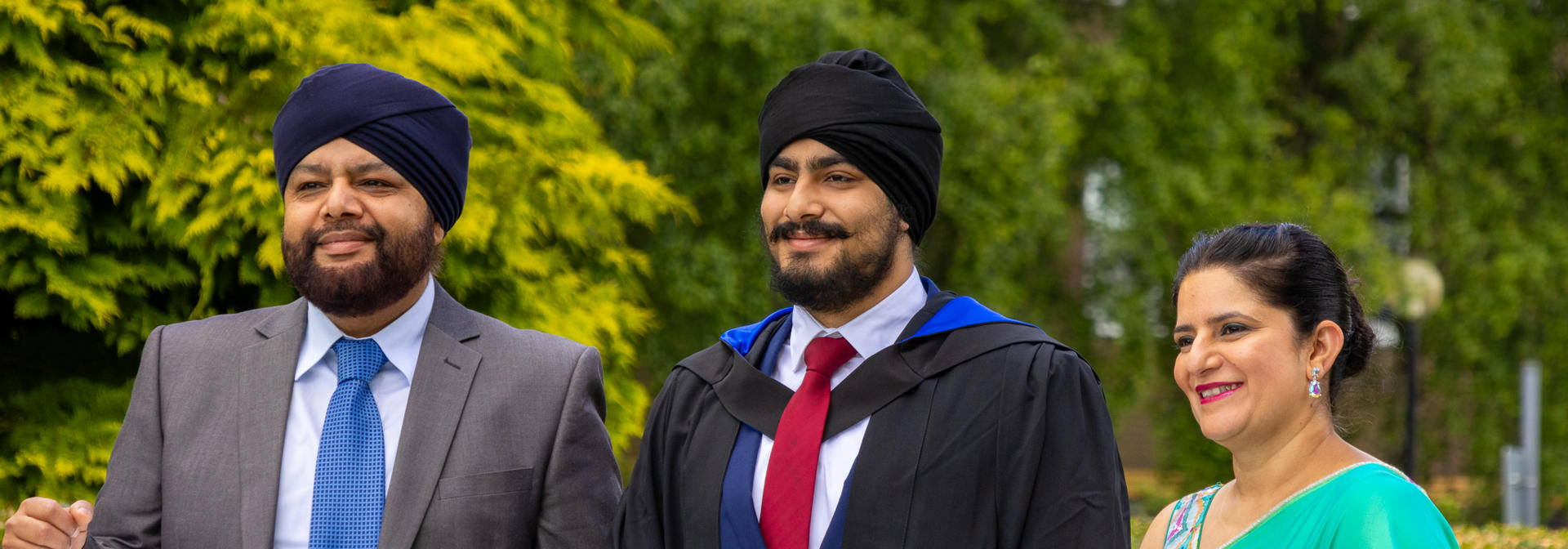 An undergraduate posing for photographs at graduation in Edinburgh.