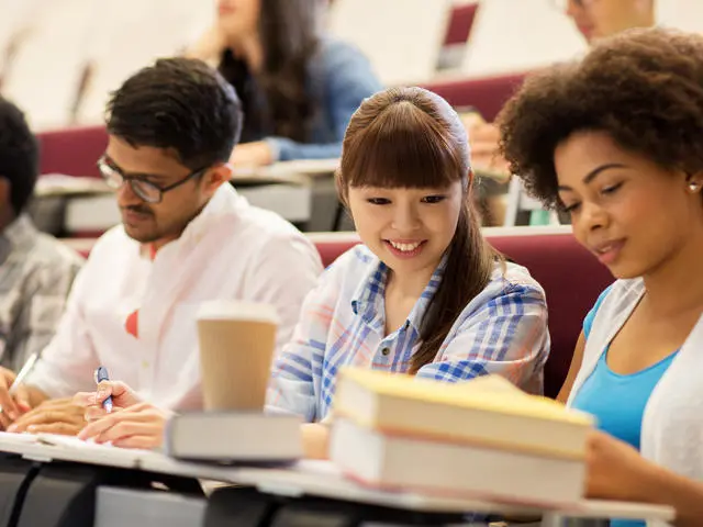 Three students in a lecture hall.