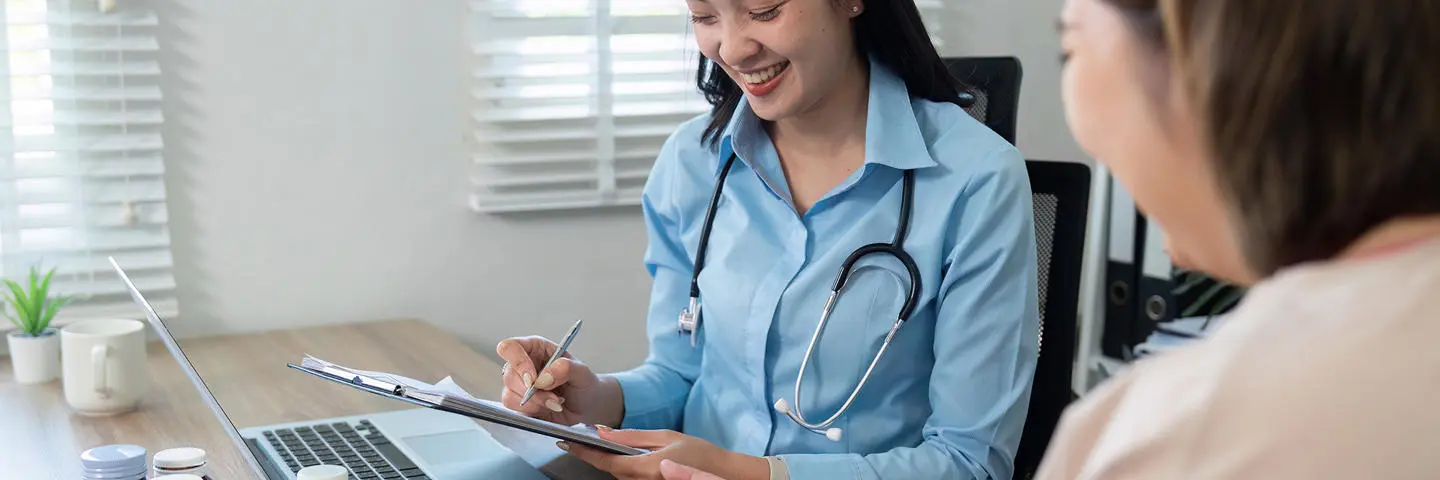 Doctor takes a patient's blood pressure.