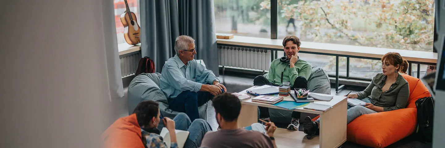 A group of students sitting on bean bags in a group discussion.