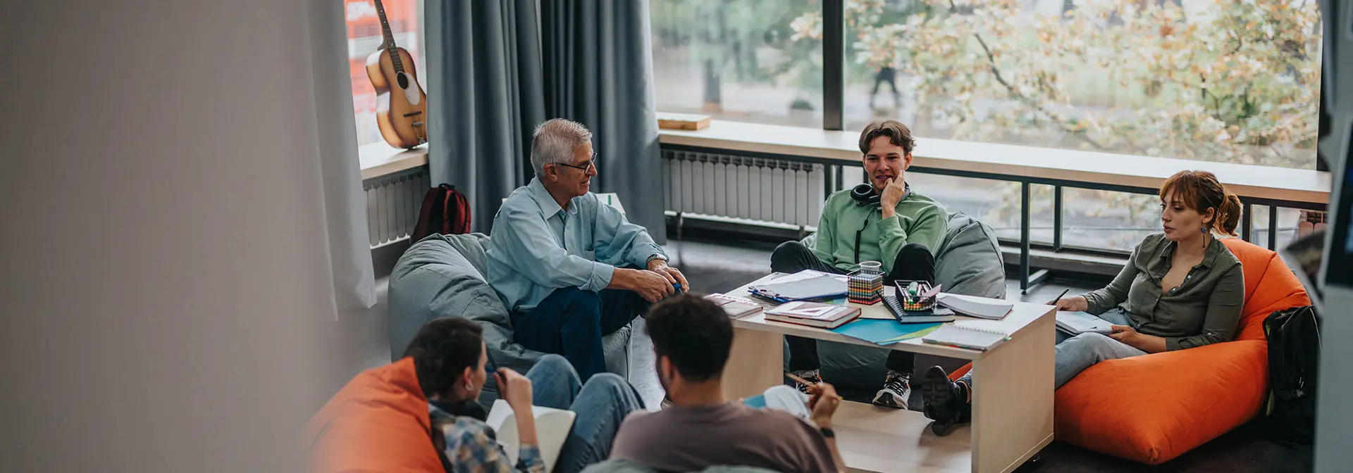 A group of students sitting on bean bags in a group discussion.