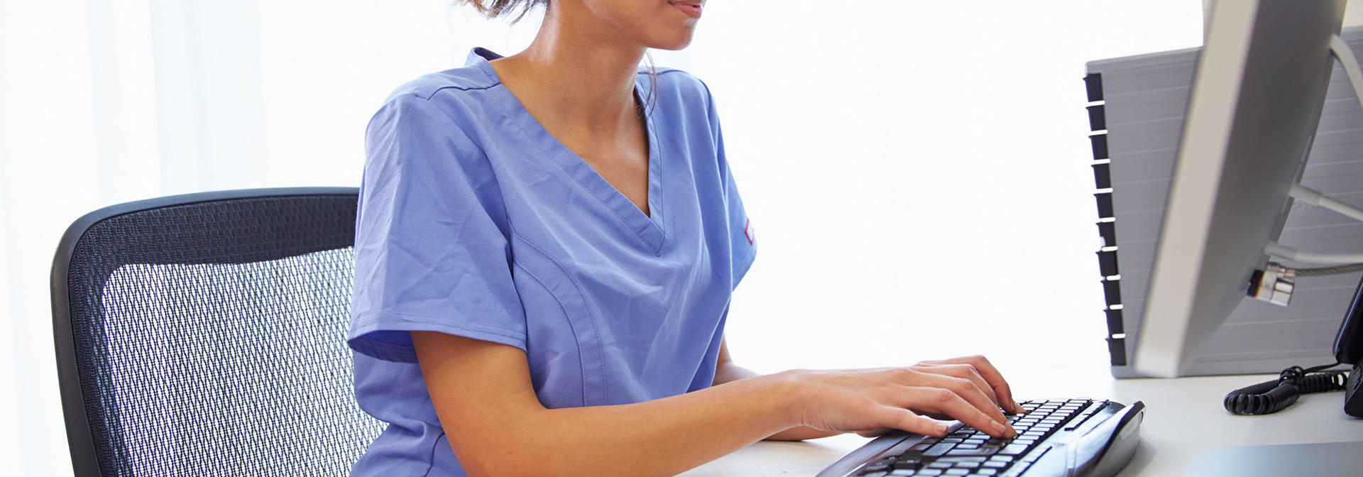 A doctor working at a computer.