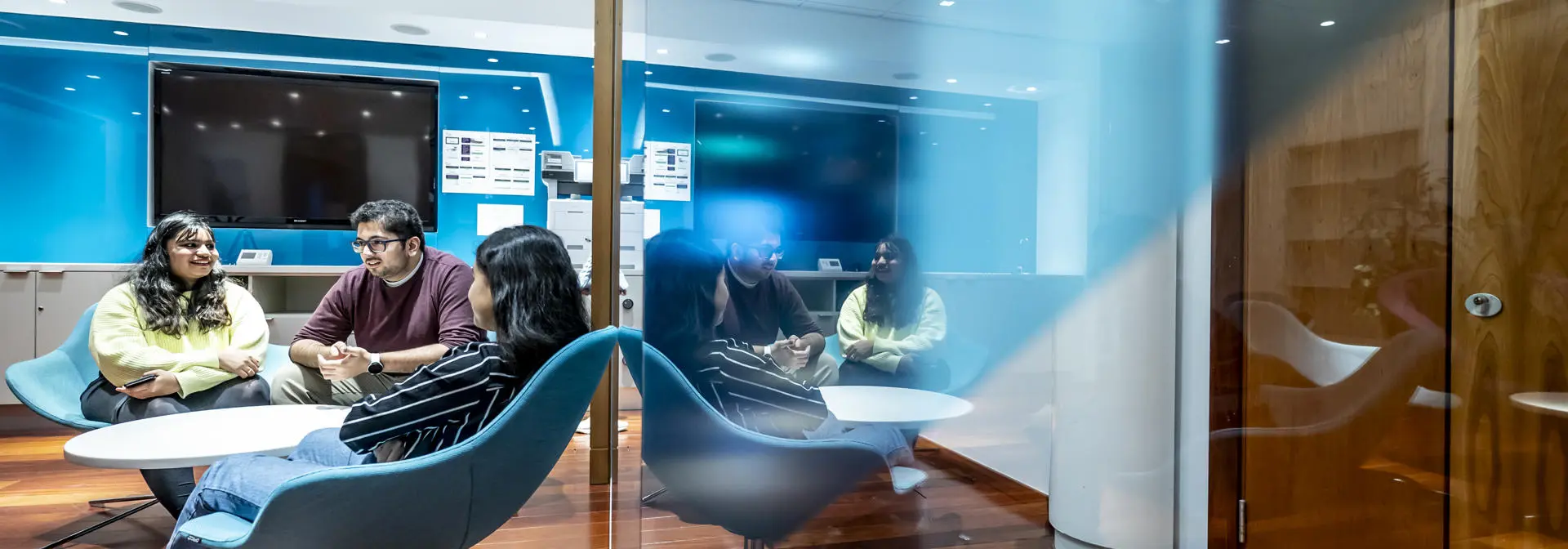 Three students meeting in a break out space
