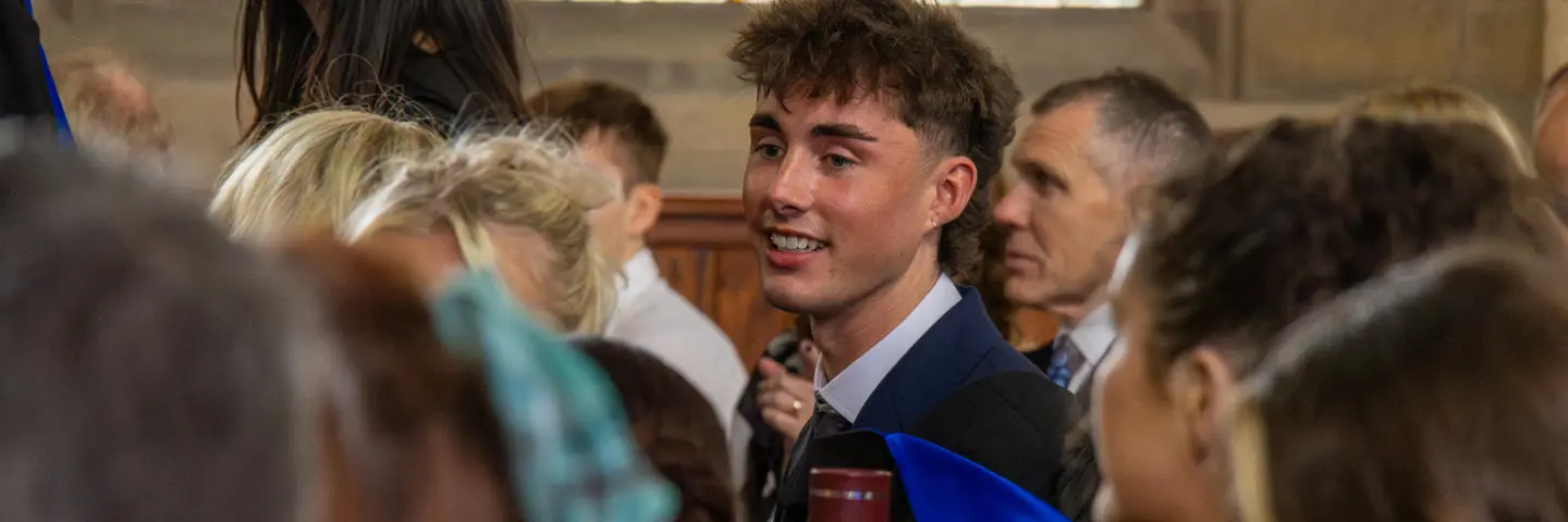 Graduates in a hall at graduation ceremony