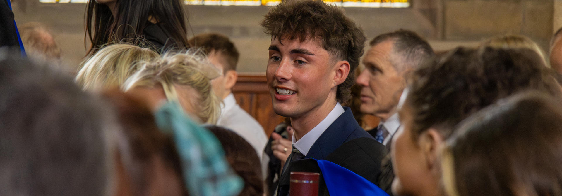 Graduates in a hall at graduation ceremony