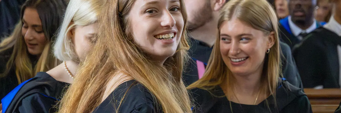 A student sits in a booth in the graduation ceremony.