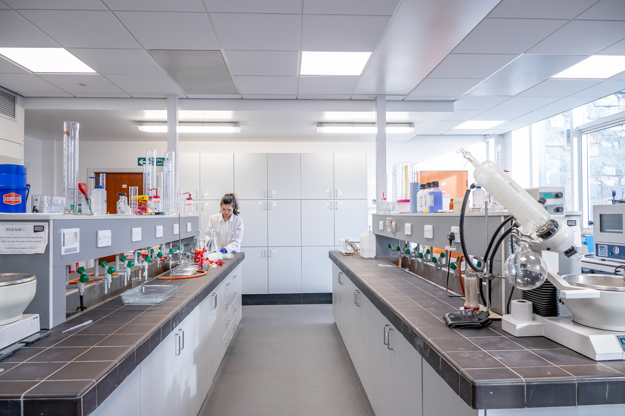 A chemical laboratory with multiple cupboards and equipment on display.