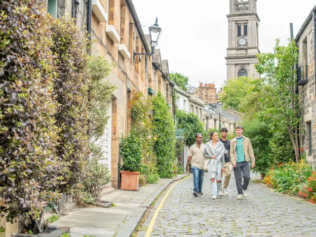 Four students walking down Circus Lane in Edinburgh