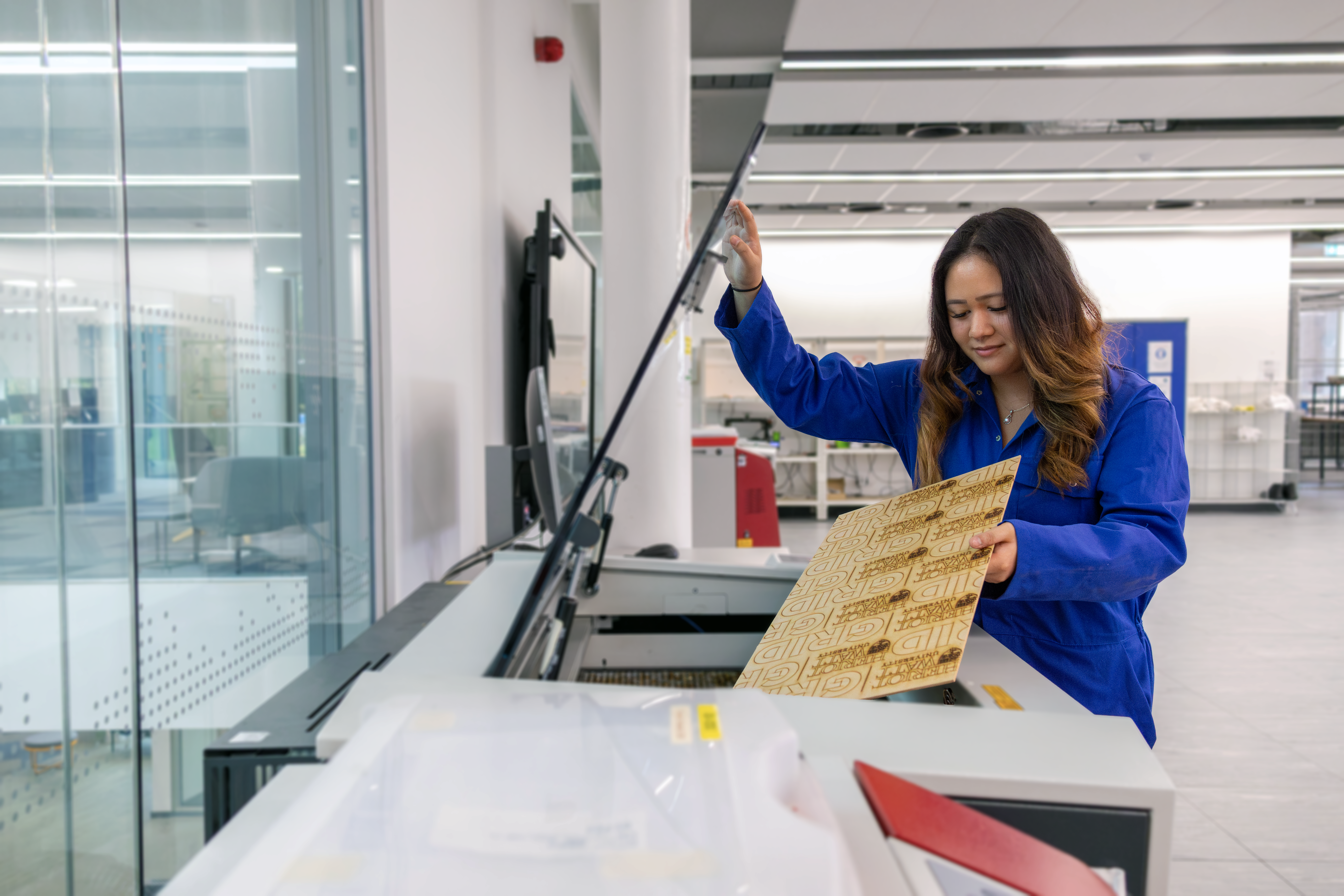 Uriel, aerospace engineering student, creating with the laser cutter machine