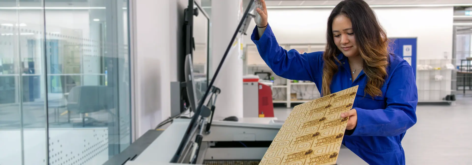 Uriel, aerospace engineering student, creating with the laser cutter machine