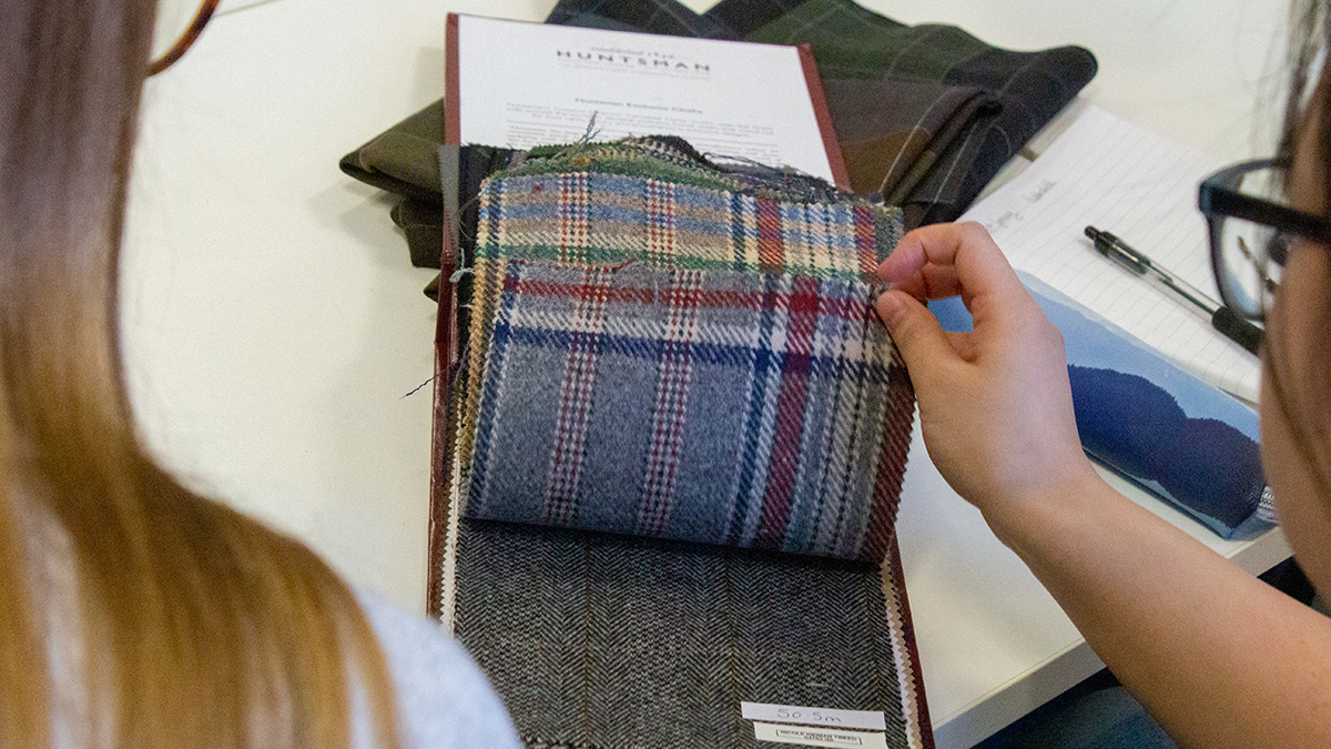 Heriot-Watt students look at fabric samples from Huntsman, the Savile Row tailor