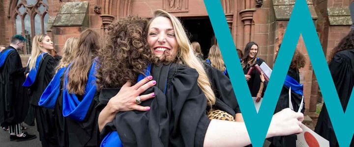 Two graduands of the School of Textiles and Design embrace after the ceremony