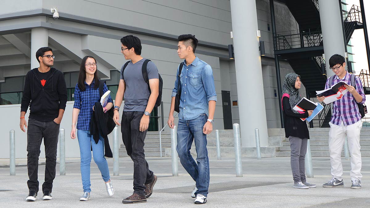 A group of students outside the Malaysia Campus main entrance