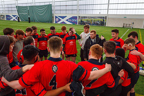 A sports team having a team talk inside Oriam
