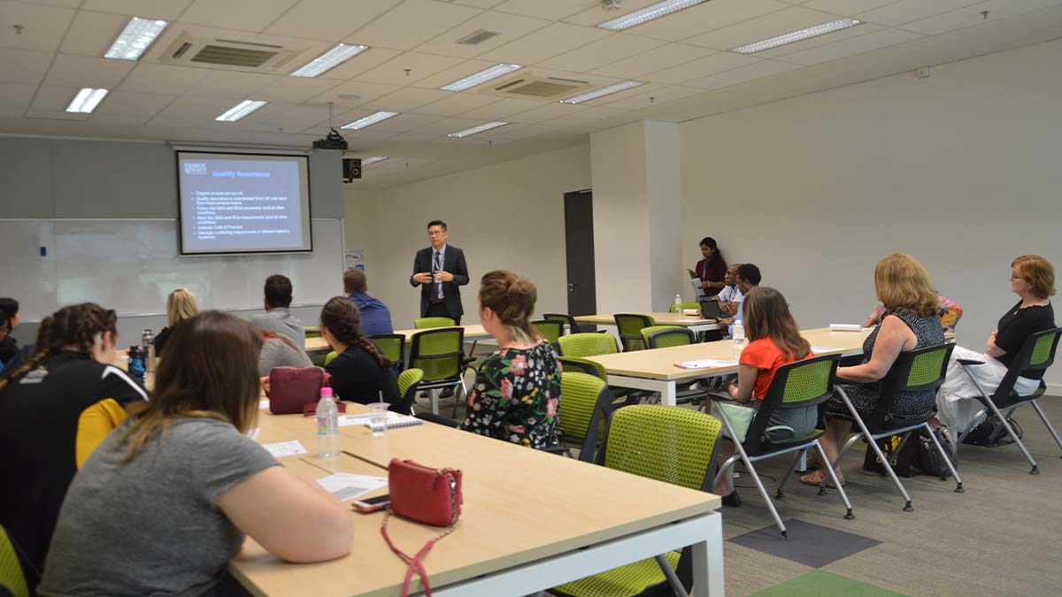 Students listening to a lecturer in a classroom