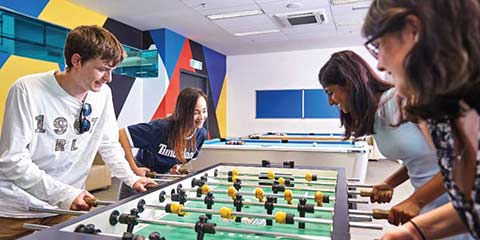 Students playing table football game