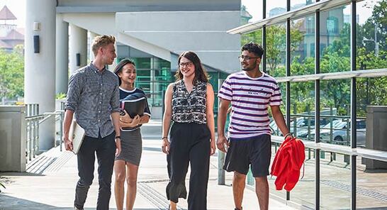 Students outside a glass-fronted building